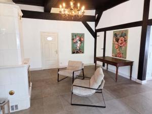 a room with a piano and chairs and a table at FH Luhe-Hof - Historisches Reetdachanwesen in Winsen +34 photos