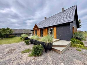 a small house with a porch and a deck at Kõpu Seaside Getaway in Rannaküla