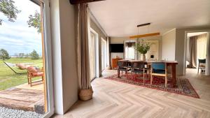a kitchen and dining room with a table and chairs at Kõpu Seaside Getaway in Rannaküla +8 photos