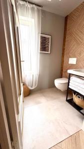 a bathroom with a toilet and a window at Kõpu Seaside Getaway in Rannaküla