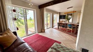 a living room with a couch and a kitchen with a table at Kõpu Seaside Getaway in Rannaküla