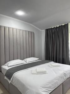 a bedroom with a large bed with white sheets at Ararat hotel in Goris