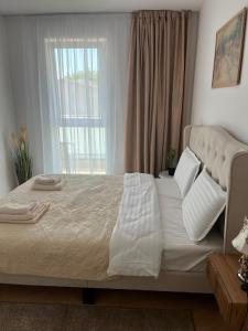 a bed with white sheets and pillows in a bedroom at Luna Residence in Baia Mare