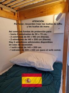 a sign above a bed with a flag on it at Studio Moderne Pied Des Pistes 4 p in La Pierre Saint Martin