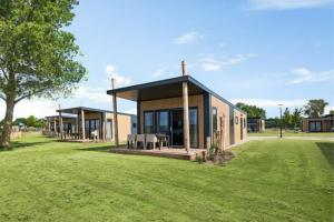 a building with a grassy field in front of it at RCN Vakantiepark de Schotsman in Kamperland +13 photos