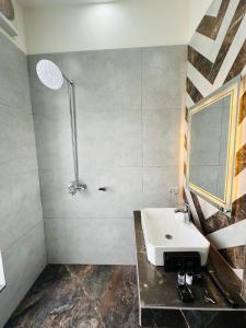 a bathroom with a sink and a shower at Hotel Haven Lahore in Lahore +29 photos