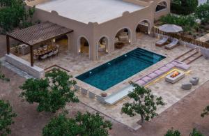 an overhead view of a house with a swimming pool at Oinopia Country Villas in Egina