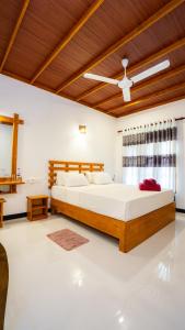 a bedroom with two beds and a wooden ceiling at Sigiriya Dreamscape Villa in Sigiriya