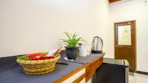 a kitchen counter with a basket of vegetables on it at Sigiriya Dreamscape Villa in Sigiriya