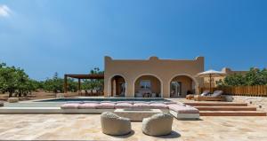 a villa with a swimming pool in the desert at Oinopia Country Villas in Egina +52 photos
