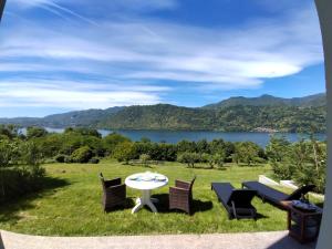 a patio with a table and chairs and a view of a lake at Holiday Home Lake Orta in Pettenasco