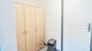a bedroom with a cabinet and a trash can at Ubytování U Hráze in Liberec +9 photos