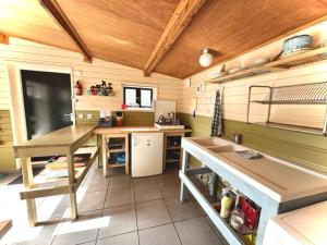 a kitchen with a table and a counter in a room at Slaaphutje BuitenWedde Westerwolde in Wedde
