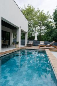 a swimming pool with blue tiles in a house at Wild River 2 in Neporotovo