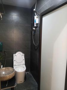 a bathroom with a toilet and a sink and a shower at Bản làng Home in Thanh Hóa +20 photos