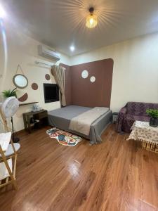 a bedroom with a bed and a wooden floor at Bản làng Home in Thanh Hóa