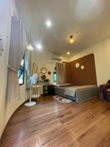 a bedroom with a bed and a desk in a room at Bản làng Home in Thanh Hóa