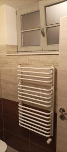 a white radiator in a bathroom with a window at Pension Johnnys in Görlitz