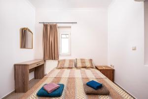 a bedroom with a bed with two pillows on it at Christiana's sweet house in Kos