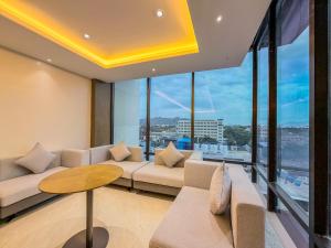 a living room with a couch and a table at Jain Tree by Spree Hotels Vellore in Vellore