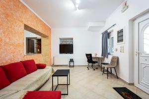 a living room with a couch and a table at Christiana's sweet house in Kos