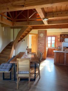 a dining room with a wooden table and chairs at Cozy Winehouse - Remote Vineyard Escape in Podčetrtek