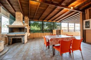 a dining room with a table and a fireplace at Christiana's sweet house in Kos