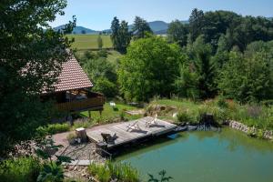 a wooden bridge over a river with a cabin at HolzHaus AusZeit am Küppel & Bright Collection in Gersfeld