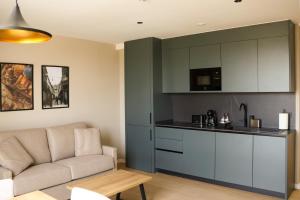 a living room with a couch and a kitchen at TeneaHome - Escuelas Pías in Yecla