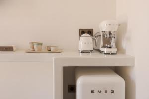 a white counter with a mixer and cups on it at Sant Blai Boutique Hotel - Javea in Jávea