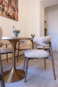 a dining room table with two chairs and a table with flowers on it at Sant Blai Boutique Hotel - Javea in Jávea