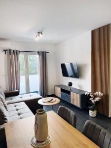 a living room with a couch and a table at Aster Apartments in Belgrade