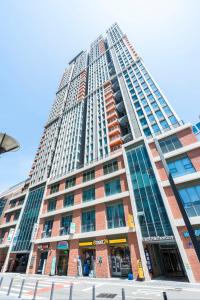 a tall building with a lot of windows at Haeon stay haeundae in Ch'ŏngsap'o