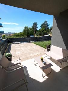 a patio with two chairs and a table at Nashi Garden Apartment Split with City View & Parking in Solin
