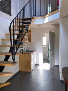 a kitchen with a staircase in a house at Mallas Stenstugu B&B in Visby +26 photos