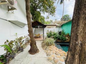 a backyard with a pool and a house at Nina's Aqua - Private Pool Villa & Plunge Pool Studios, Anjuna in Anjuna