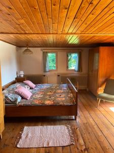 a bedroom with a bed and a wooden ceiling at Ubytování v Roubence in Modřišice
