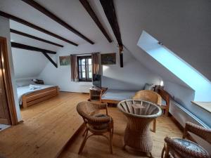 a living room with a table and chairs at Penzion U Dračice in Nová Bystřice