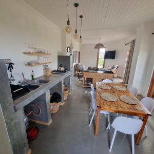 a kitchen and dining room with a table and chairs at Oudam Cottage in Carnarvon