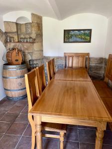 a wooden table in a room with a wine barrel at Ubytování v Roubence in Modřišice