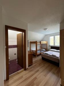 a bedroom with a bed and bunk beds in it at Villa Pjene in Konjic