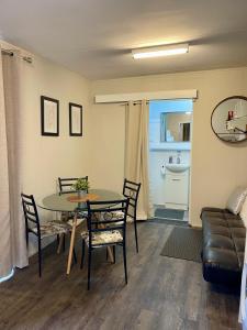 a living room with a table and chairs and a couch at Murray Bridge Riverview cabin in Murray Bridge