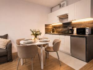 a kitchen and dining room with a table and chairs at Apartament 1go Maja TK in Namysłów