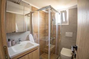 a bathroom with a shower and a sink and a toilet at Saronic View Studio in Agioi Theodoroi +22 photos