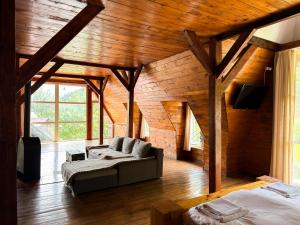 a living room with two beds and a couch at Salo I Mandry Apartment in Rakhiv