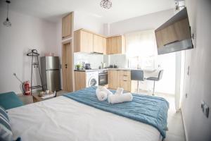 a bedroom with a bed with two towels on it at Saronic View Studio in Agioi Theodoroi
