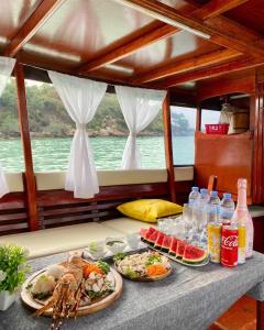 a table with two plates of food on a boat at Sibsansmuth Resort in Ko Larn
