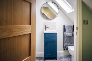 a bathroom with a sink and a mirror at Mill Farm in Gamlingay