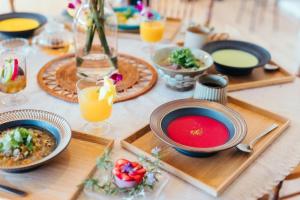 a table with plates of food and glasses of orange juice at MANANI - Vacation STAY 16612v in Nago +14 photos