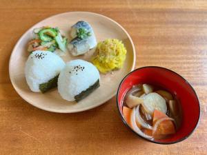a plate of food with sushi and a bowl of soup at MANANI - Vacation STAY 16612v in Nago